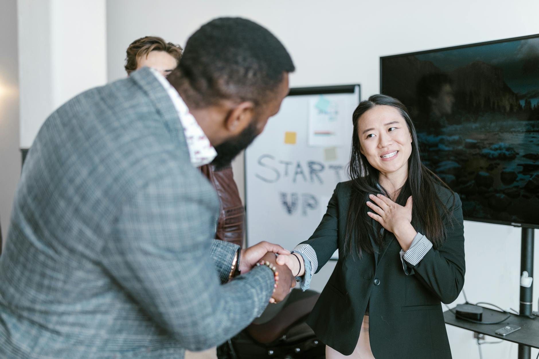a man shaking a woman s hand
